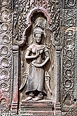 Ta Prohm temple - devatas sculpted on the gallery walls 